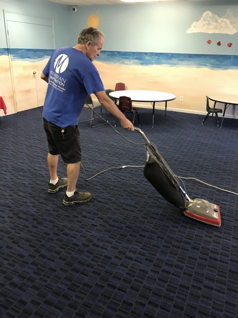 McFarran School Janitor Vacuuming Classroom Floor